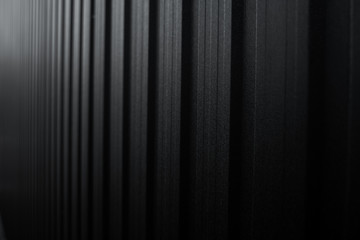 Black Corrugated metal sheet surface of the wall. Galvanize steel background.