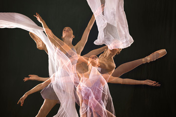 Multiple exposure of ballerina in purple, dancing with white fabric.