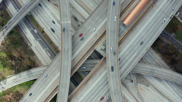 AERIAL: Spectacular Overhead Shot of Judge Pregerson Highway showing multiple Roads, Bridges, Viaducts with little car traffic in Los Angeles, California on Beautiful Sunny Day