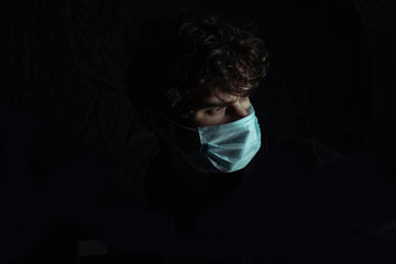 Portrait of man in medical mask close-up in studio. young man in medical mask against viruses and infections. Coronavirus 2019-ncov covid-19 concept.