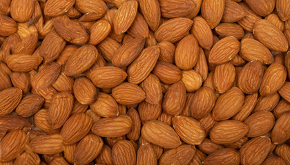 Natural closeup of almonds making a seamless background