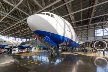 Passenger aircraft in the hangar. Maintenance preparation