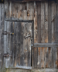 Old wooden brown door, brown boards, vintage decrepit texture
