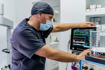 Veterinarian checking hear rate monitor in clinic