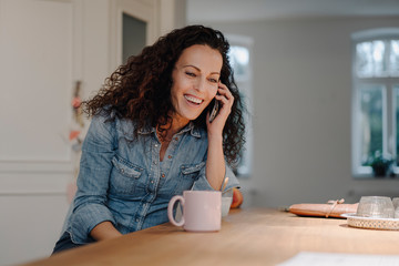 Woman talking on the phone at home