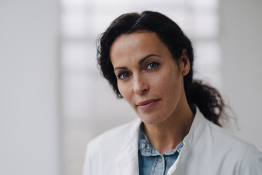 Portrait of confident female doctor, looking at camera