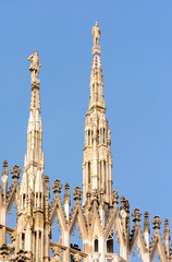 Cathedral of the Nativity of the Virgin Mary in Milan. Cathedral of white marble. The Late Gothic building contains many spiers and sculptures, marble peaked towers and columns.