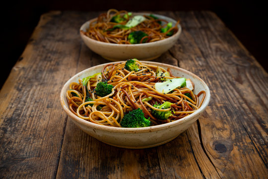 Bowls of Japanese?soba?noodles with?bok?choy, broccolies, soy sauce and black sesame