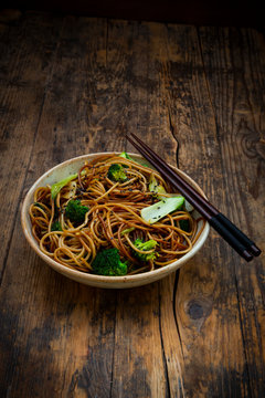 Bowl of Japanese soba noodles with bok choy, broccolies, soy sauce and black sesame