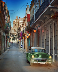Old green classic car on the streets of Havana