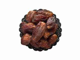 Isolated Saudi Medjool dates fruits in a bowl.