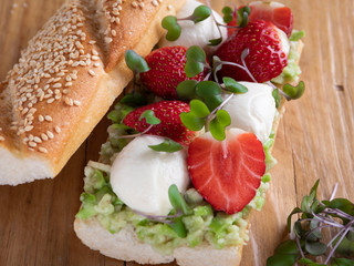 sandwich baguette with strawberries, mozzarella cheese, guacamole close up