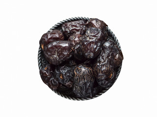 Isolated Saudi Ajwa dates in a bowl.