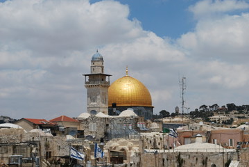 Obraz premium View toward the Dome of the Rock in Jerusalem past a minaret and rooftops of the old city. 