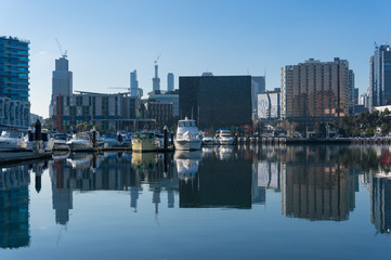 Fototapeta na wymiar Docklands cityscape with marina, yachts and skyscrapers