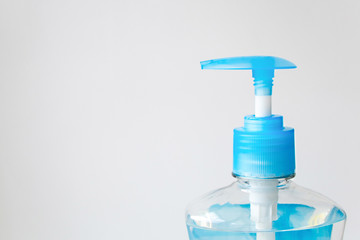 Close up plastic bottle with blue cap. Liquid soap container with blue dispenser