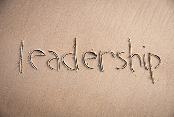 Handwritten message of leadership written in clean smooth sand