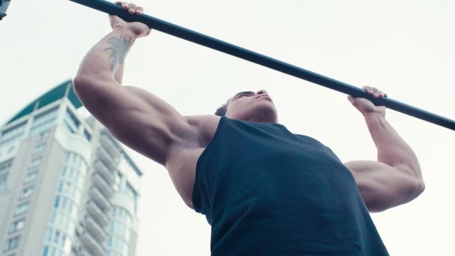 Low angle view of sportsman training on horizontal bar
