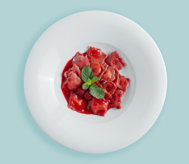 vareniki. dumplings with raspberries. Ukrainian food. on a white background. top. view from above