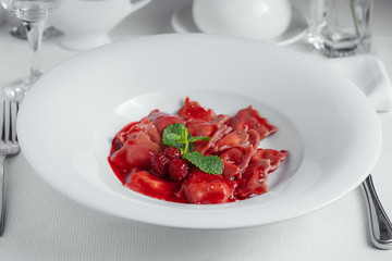 vareniki. dumplings with raspberries. Ukrainian food. on a white background