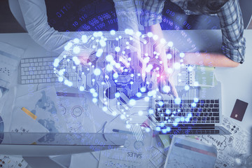 Double exposure of man and woman working together and human brain hologram drawing. Brainstorm concept. Computer background. Top View.