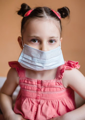 Kid girl wearing protection face mask against coronavirus