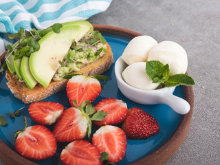 toast with guacamole, avocado, strawberries. mozzarella cheese  healthy eating