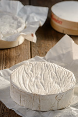Close up on a whole Camembert cheese wheel just from the box