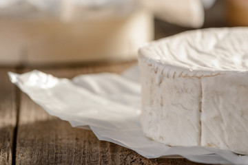Close up on Camembert cheese wheel on a wooden table