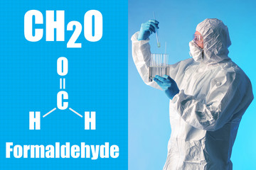 Formaldehyde. CH2O. Man holds several test tubes. Lab technician holds glass flasks in his hands....