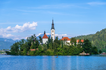 Fototapeta na wymiar Amazing view on Bled Lake with church dedicated to the Assumption of Mary on a small island, Julian Alps, Slovenia