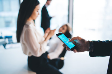 Business employee standing and using smartphone