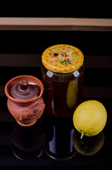 Honey in a jar and tea on a wooden table