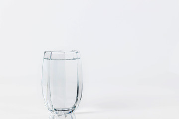 Glass with water on a white background. Glass of mineral water on white background.