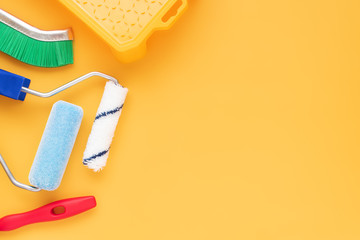 tools for repairing an apartment - roller, brush, paint tray. flat lay with place for text. housing construction and repair concept