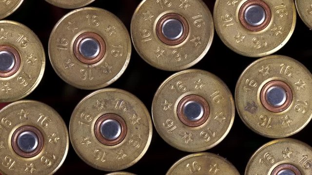 Closeup weathered green ammo cartridges for modern firearm stacked together in rows