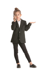 Little businesswoman talking by mobile phone on white background