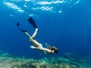 Female tourist love extreme sport practicing scuba diving during holiday on Bahamas, woman in swim flippers exploring ocean depth enjoying Indonesian adventure for discovering aquatic nature life