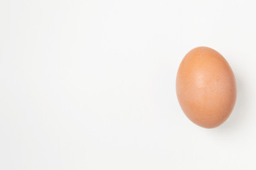 Close up of an egg lying on a white background. There is a place for text. Easter concep.