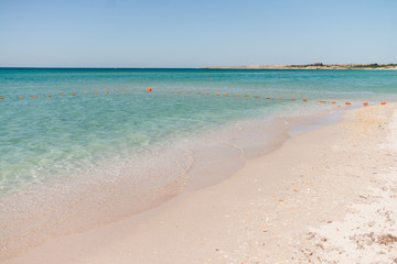 Fototapeta na wymiar Wonderful landscape of turquoise sea and white sand. Sea with safe buoys. Holiday and honeymoon concept.