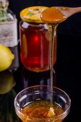 Honey in a jar and tea on a wooden table