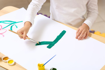 Cute little girl painting at home