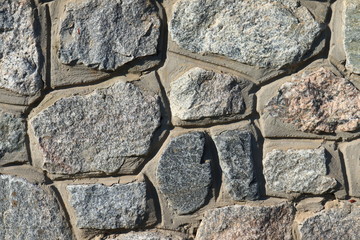 Stone wall as a background.Decorative natural stone. Natural decoration of the facade of the house, building