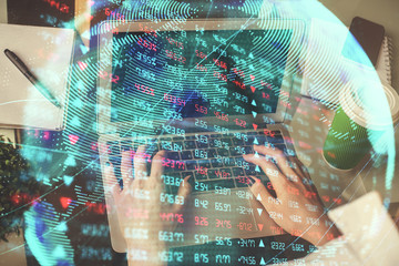 Double exposure of woman hands typing on computer and business theme hologram drawing. Success...