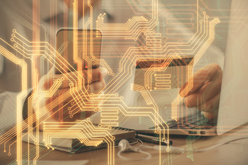 Double exposure of man hands holding a credit card and tech theme drawing. Technology in E-commerce concept.