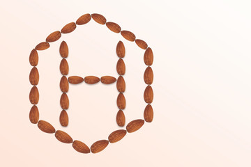 Letter H of the English alphabet from nuts in hexagon shape. Food pattern made from nuts alphabet for shop and diet