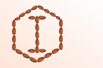 Letter I of the English alphabet from nuts in hexagon shape. Food pattern made from nuts alphabet for shop and diet