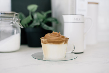 Dalgona coffee. Whipped instant coffee over cold milk.