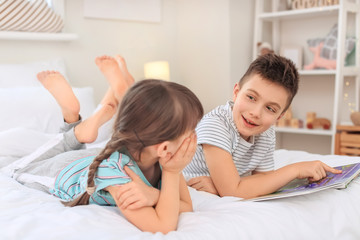Fototapeta premium Little children reading bedtime story at home