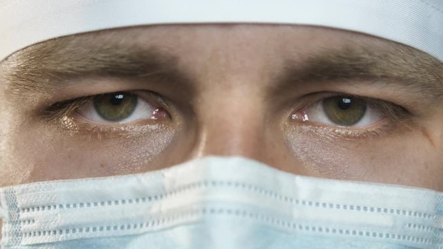 Closeup portrait of a young surgeon, doctor with mask ready to work in a hospital or clinic. Eyes of a doctor